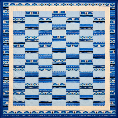 Light blue and blue geometric print quilt with staggered squares and cream border, Sandra Mianscum