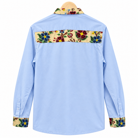 Back view of a light blue Cree ribbon shirt with floral and ribbon details by Alexandria Coon of Mistissini.
