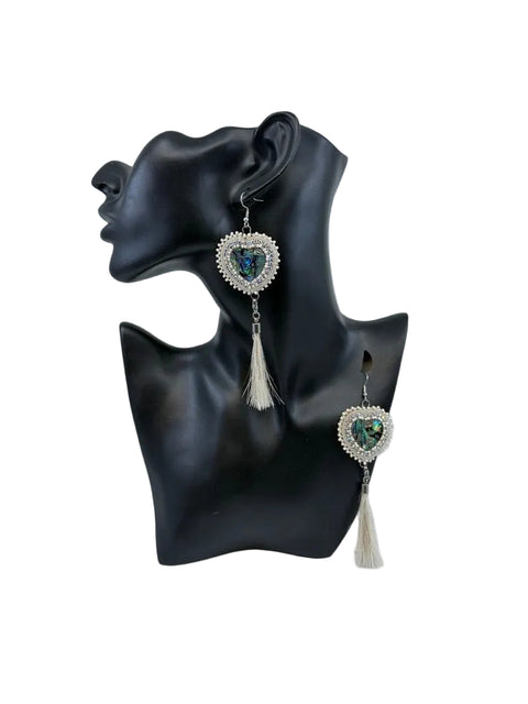 Beaded moosehide abalone shell heart earrings with horse hair by Ironstar Co shown on display