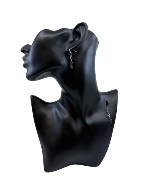 Small stainless steel leaf earrings by Jolene Robichaud shown worn for scale