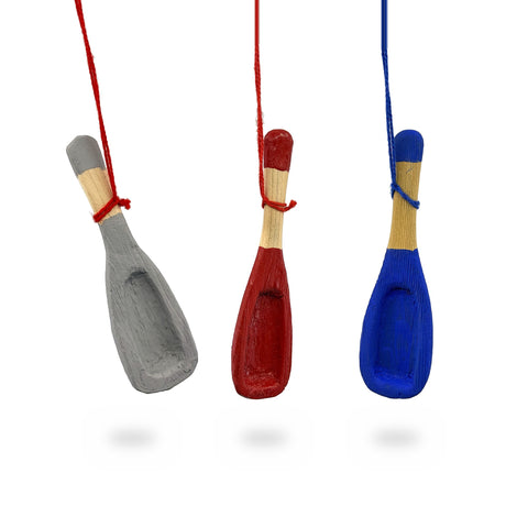 Grey, red and blue painted wood mini snow shovel ornaments with hollowed blades, hanging from strings, by Gordon H. Blackned